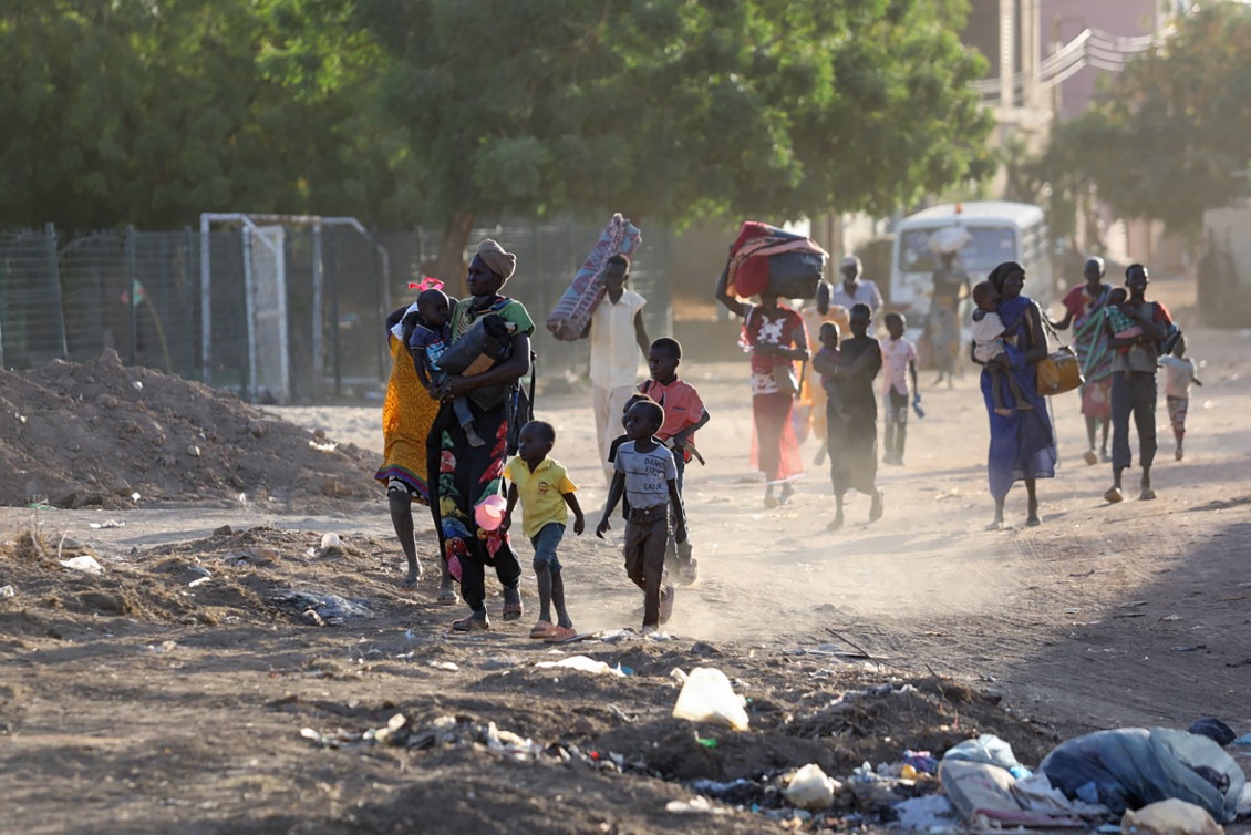 People flee their neighborhoods amid fighting between the army and paramilitaries in Khartoum on April 19, 2023, following the collapse of a 24-hour truce.